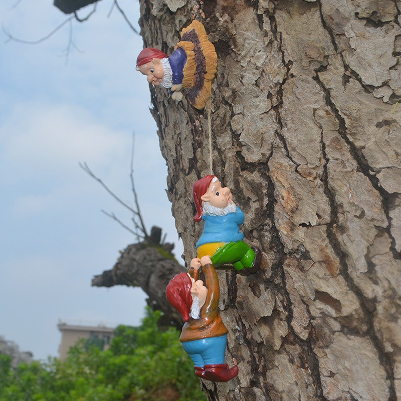 Close view of hand-painted gnome faces in bright hats and shirts