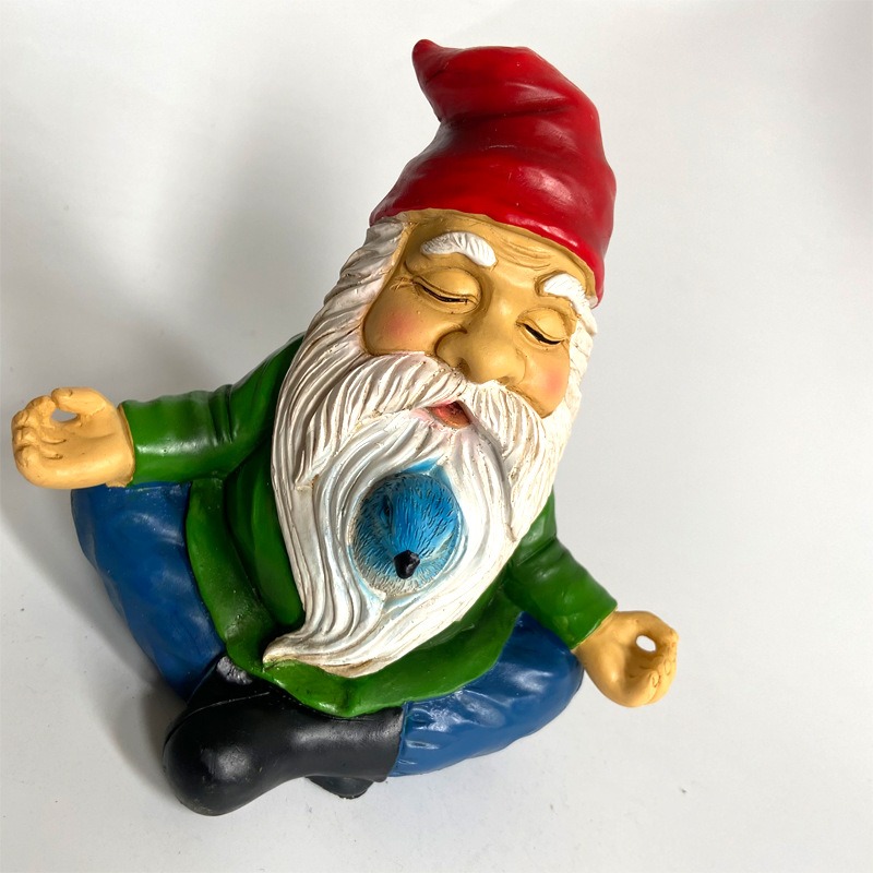Resin meditating gnome with red hat and blue bird, ready to place in a yard