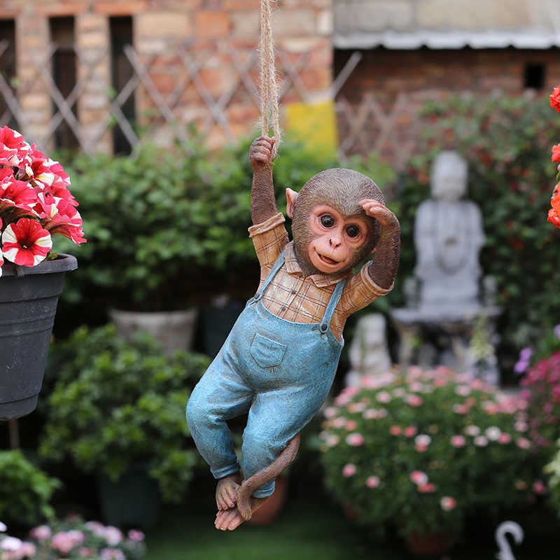 Resin monkey figure in a garden setting with soft daylight