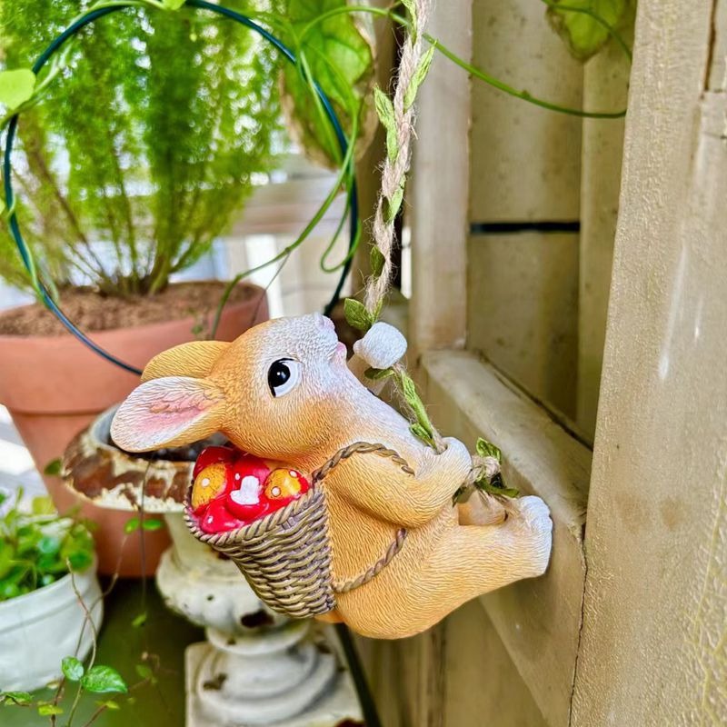 Rabbit ornament on a wall ledge beside potted green plants