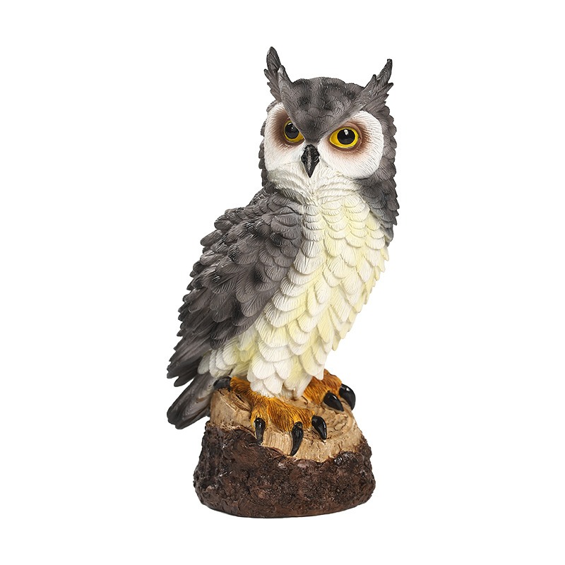 Grey resin owl on a bark-textured stump with feather detail visible