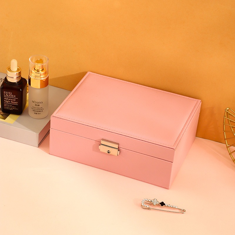 Closed pink jewelry box with gold-tone lock on the front