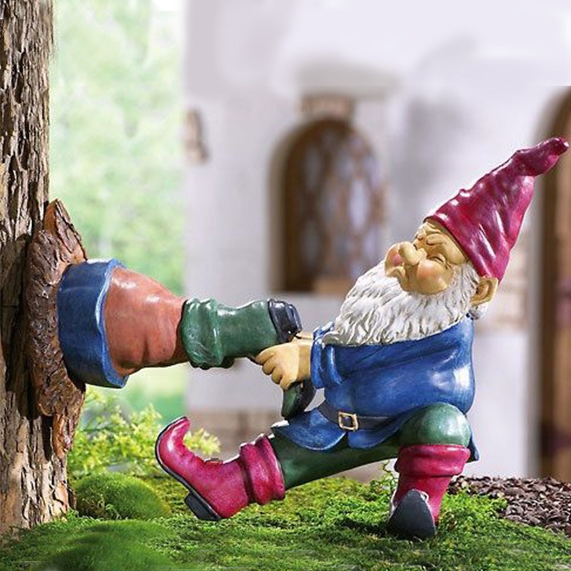 Close view of painted gnome figurine with red hat and detail