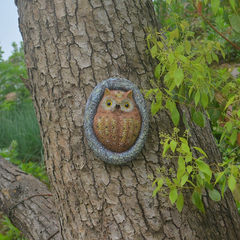Garden wall corner with owl decor and greenery around it
