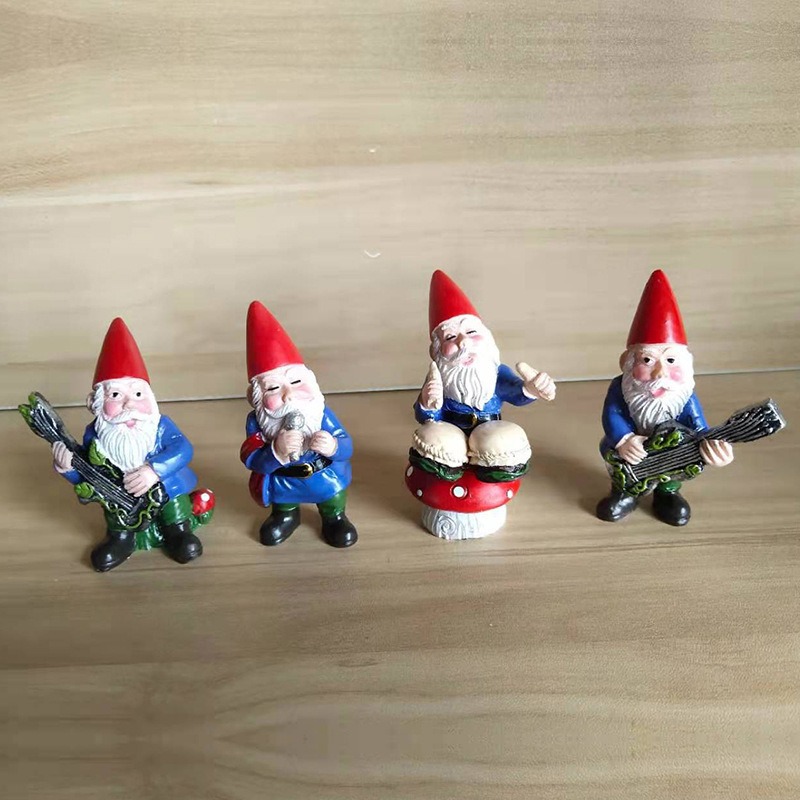 Four gnome figurines standing together on a wooden tabletop