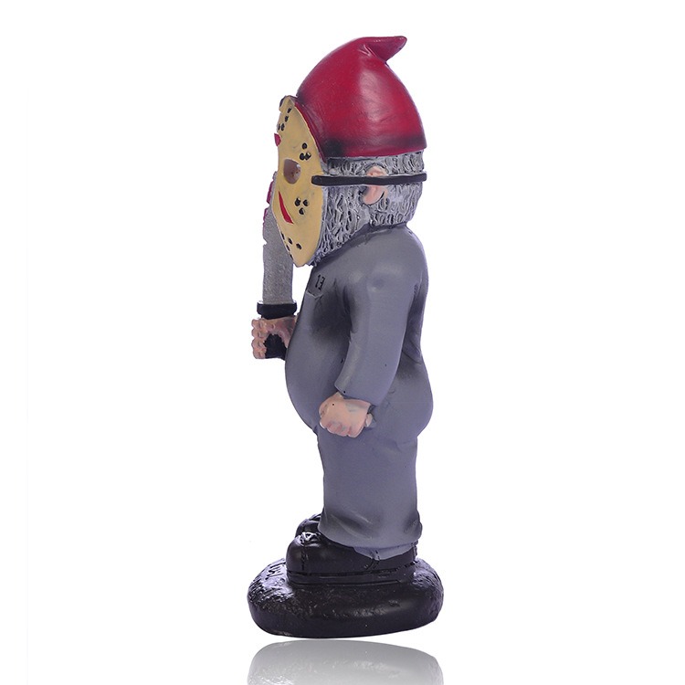 Side profile of a masked gnome figurine holding a blade