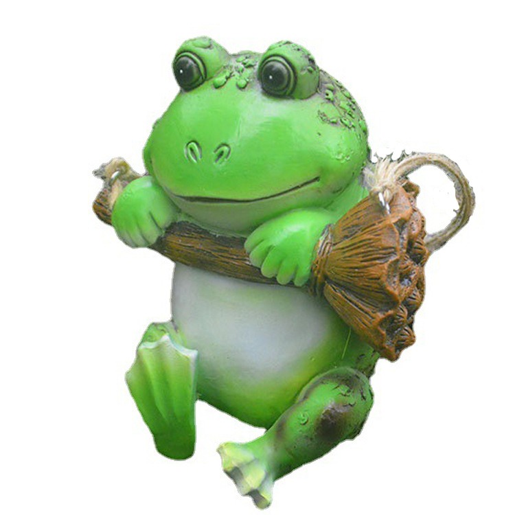 Side view of a green frog pendant holding a wooden log with jute cord