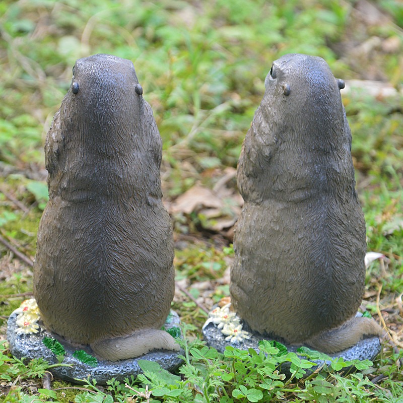Rear view of a groundhog figurine showing tail sculpting and flat base