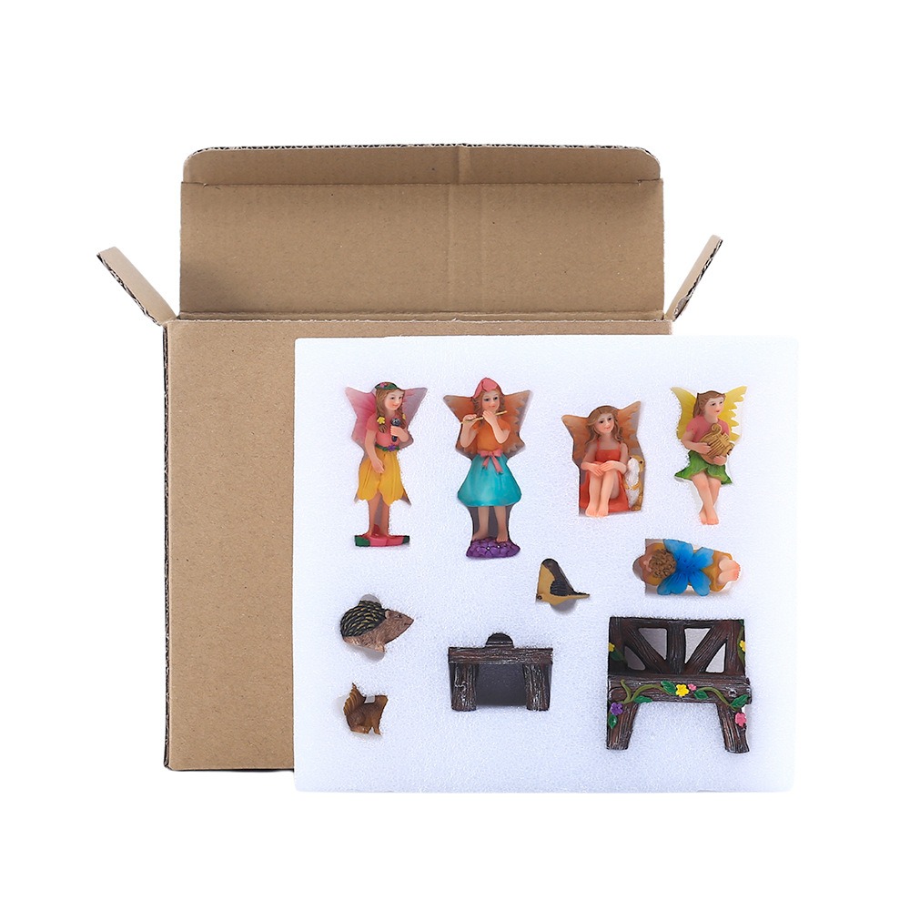 Kraft gift box opened with white foam insert holding the fairy pieces