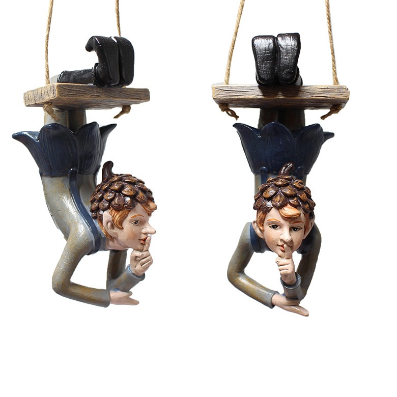 Elf pendant hung on an outdoor branch among leaves