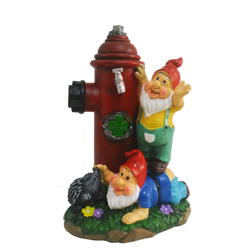 Front view of gnome and hydrant figurine with painted faces and clothing