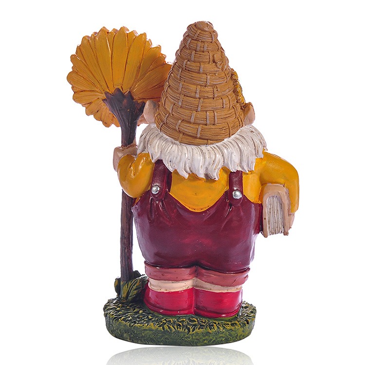 Back view of resin gnome showing woven hat texture and sunflower staff