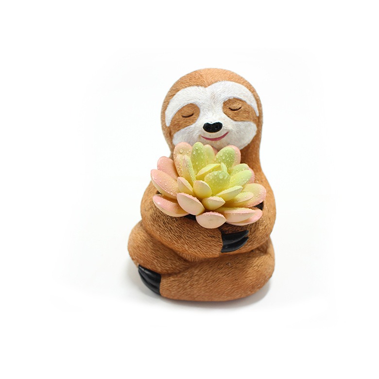 Sloth planter with pale green and pink succulent cradled against its chest