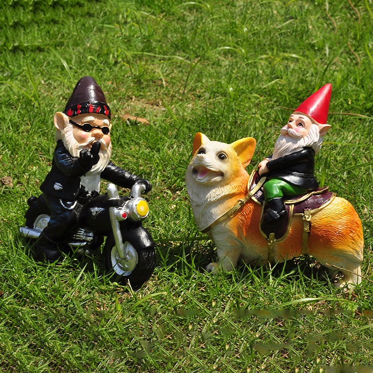 Gnome-on-corgi figurine set on grass beside a themed garden figure