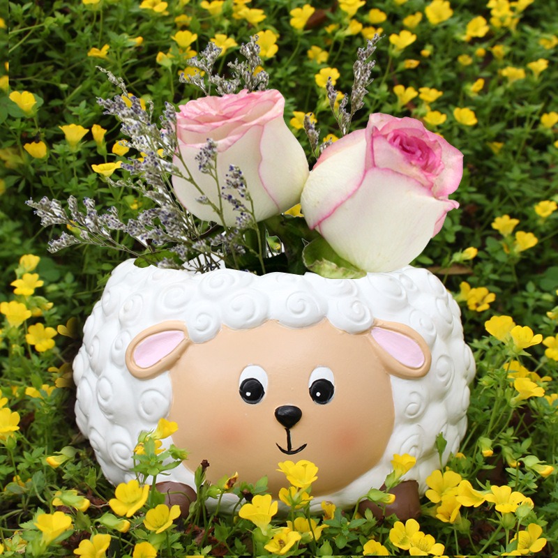 Lamb planter filled with pink roses and lavender sprigs on a table
