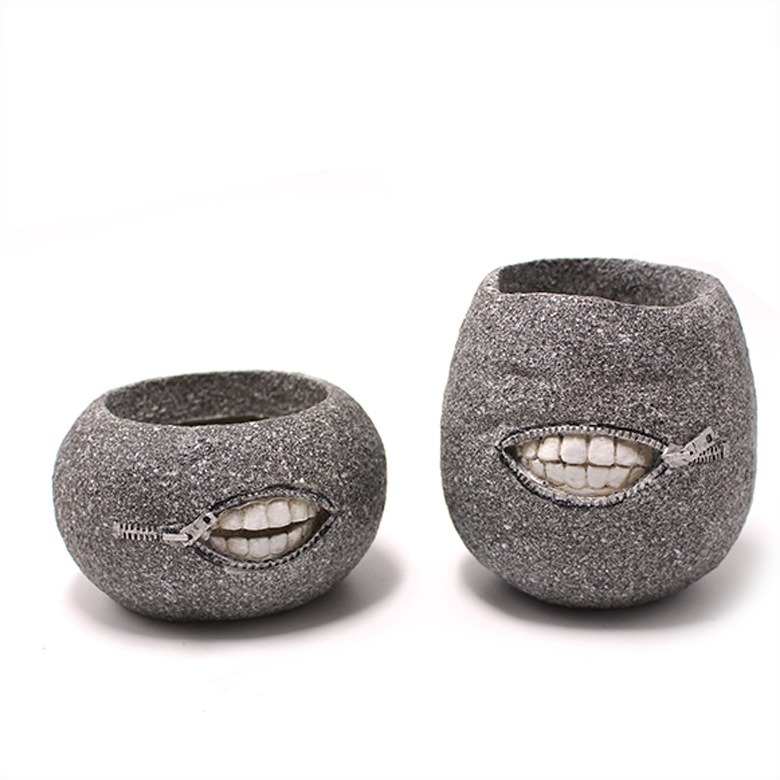 Side view of grey planter with zipper mouth and molded white teeth