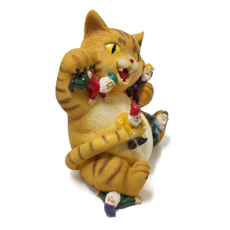 Side view of orange tabby cat figurine with gnomes scattered across its body