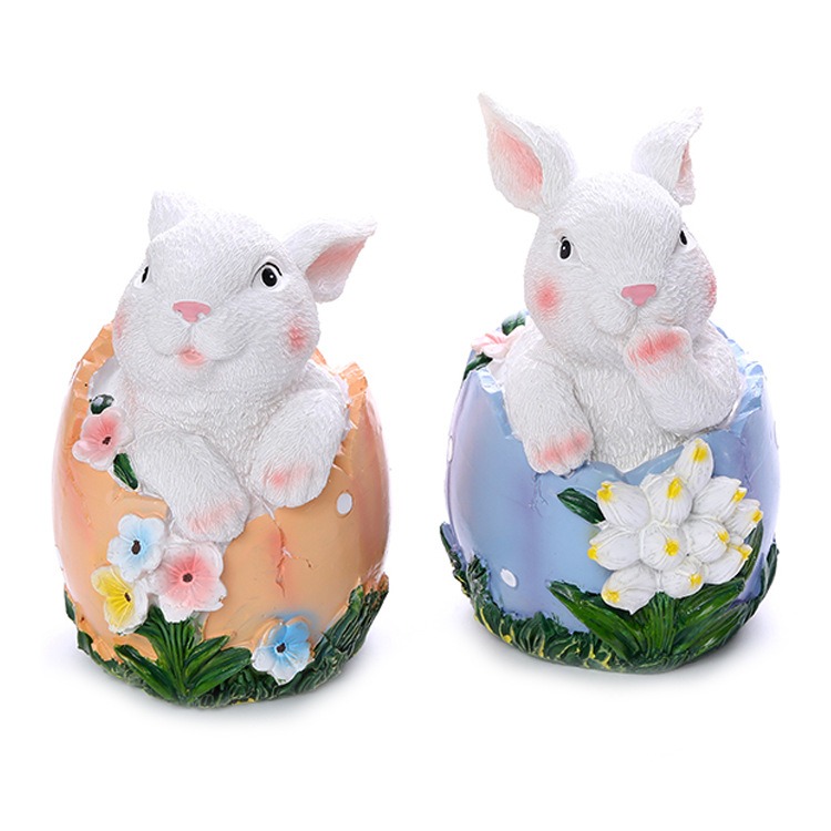 Resin bunny among spring bulbs in a garden bed setting
