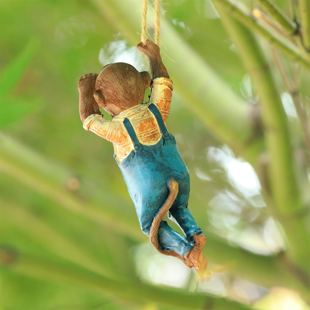 Back view of resin monkey showing hand-painted detail and rope
