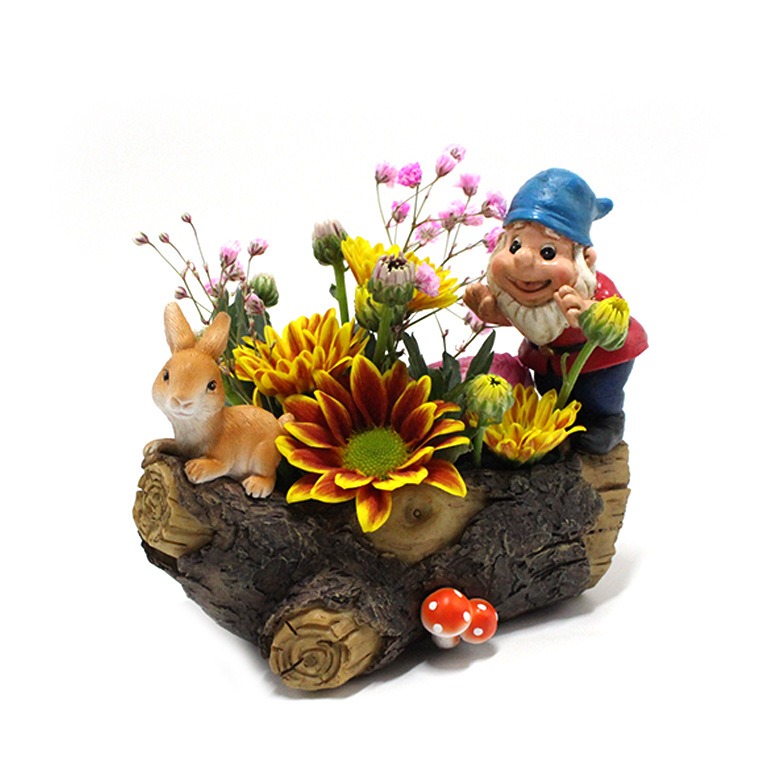 Close-up of hand-painted gnome face on bark-textured log planter