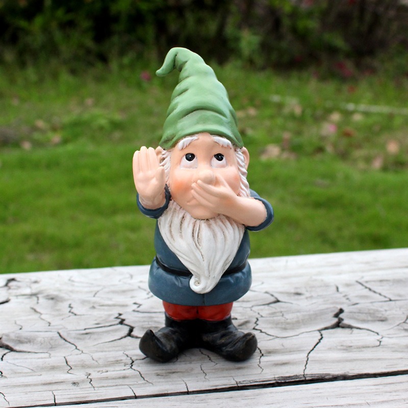 Garden gnome standing on a weathered wooden bench in front of lawn