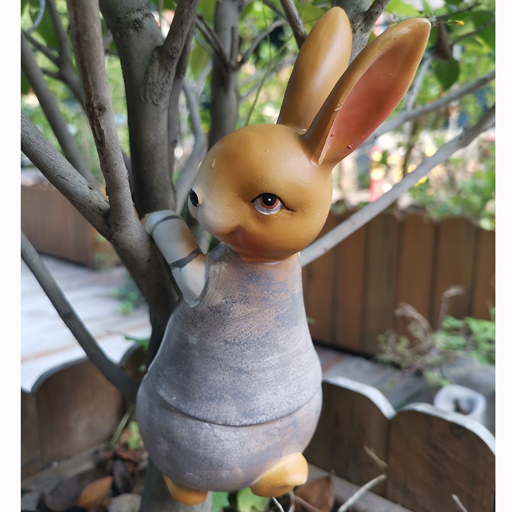 Rabbit and frog figurines arranged in a playful garden corner