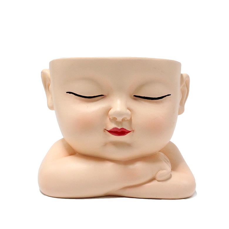 Sleeping baby face with painted cheeks, lips and closed eyes