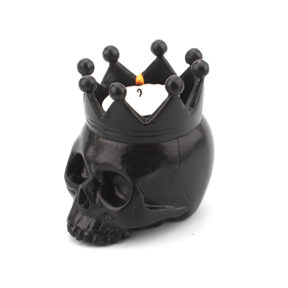 Black skull crown candle holder with a lit tealight inside the crown