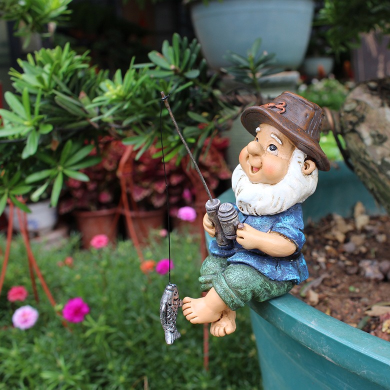 Seated fisherman gnome arriving with planter, rod and wooden ladder
