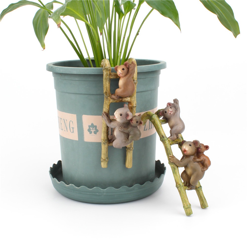 Close-up of hand-painted koala faces on a bamboo-style ladder