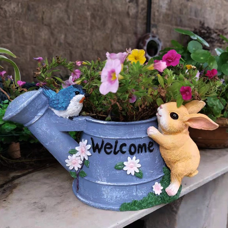 Planter filled with pink, purple and yellow flowers on a stone ledge