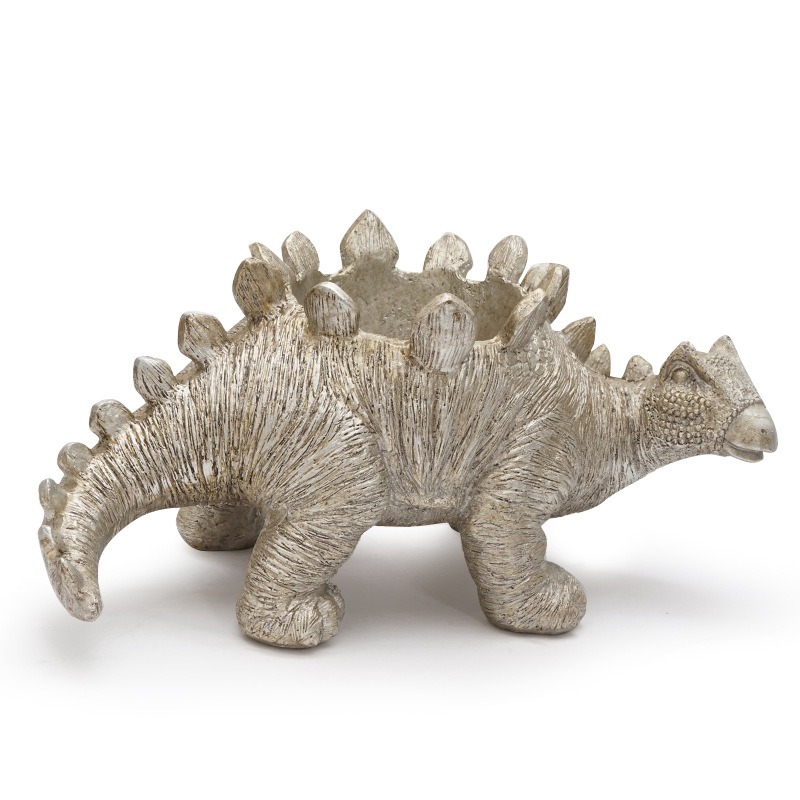 Side view of silver stegosaurus resin planter with curved tail and textured body