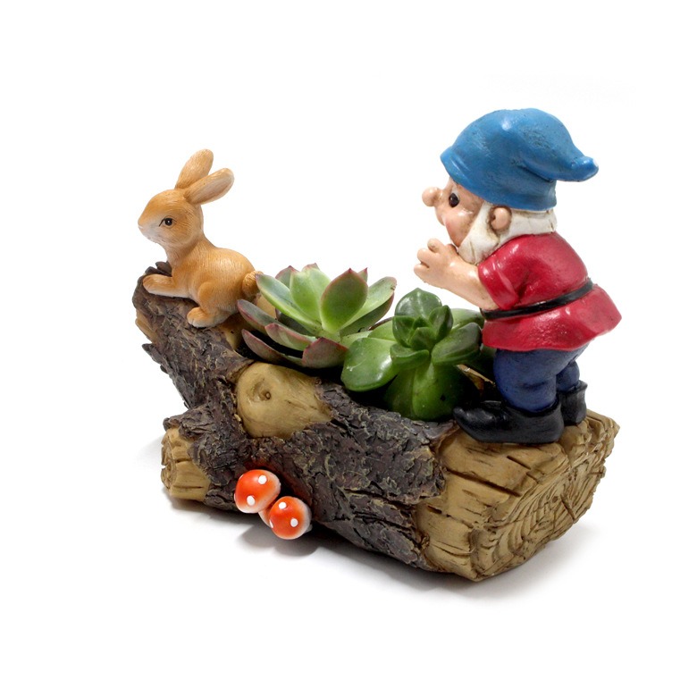 Gnome figurine and sitting rabbit on a resin log planter with succulents