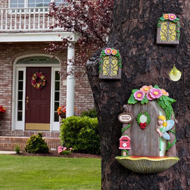 Fairy door set on a tree trunk beside a brick house at home scale