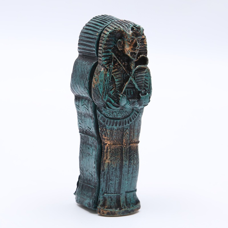 Side view of closed mummy case with pharaoh face and carved wrapping