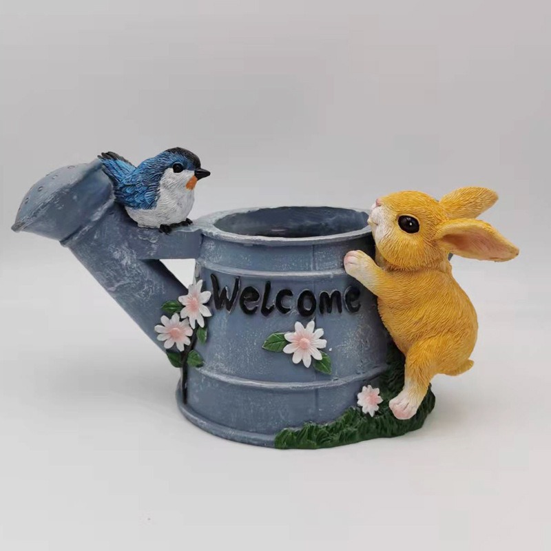 Close-up of sculpted bluebird and painted daisies on the planter