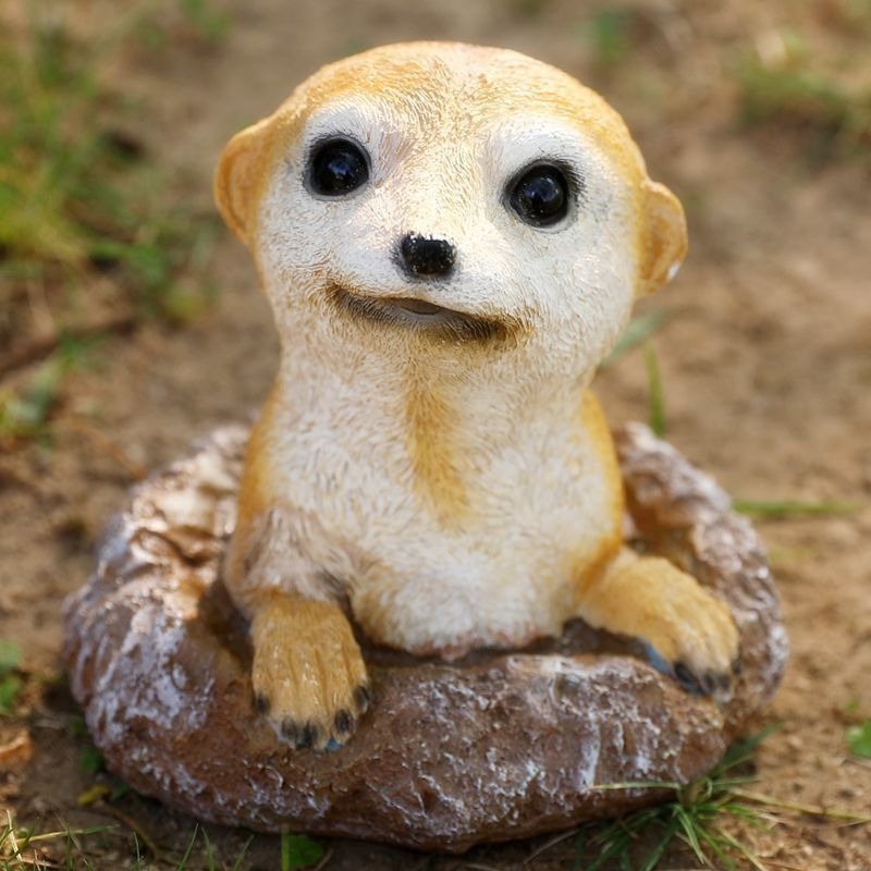 Close-up of meerkat face with painted eyes and sculpted fur