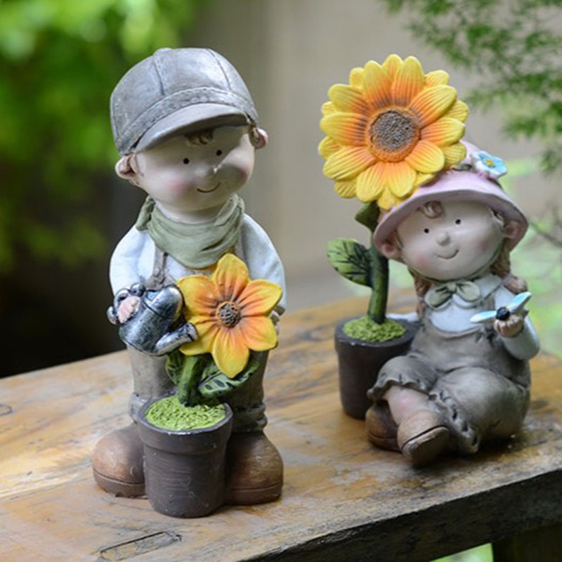 Wooden ledge outdoors with two garden figurines and flower pots