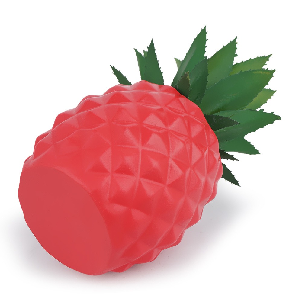 Glossy red resin pineapple pot with green agave leaves in a tidy room