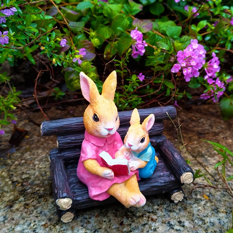 Close-up of rabbit figurine fur detail beside purple flowers
