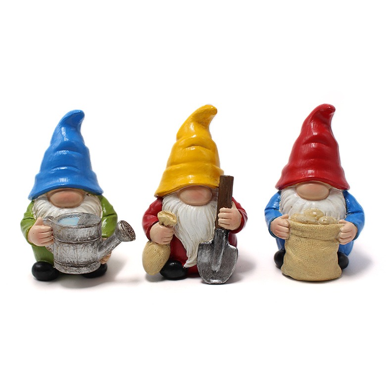 Front view of three gnomes with watering can, shovel and sack