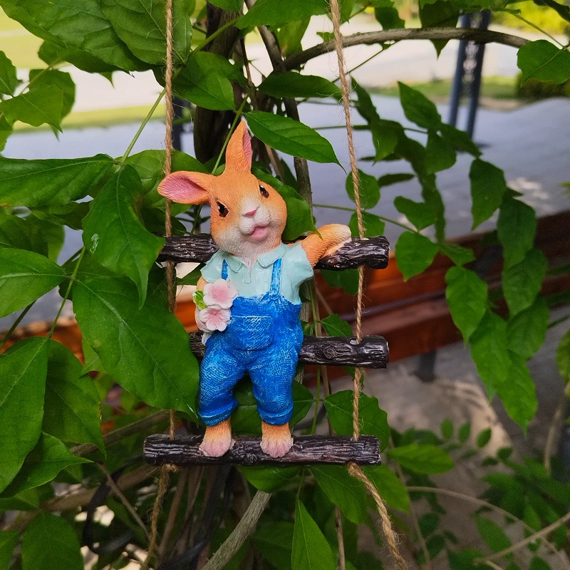 Close-up of painted resin rabbit fur and blue overalls outdoors