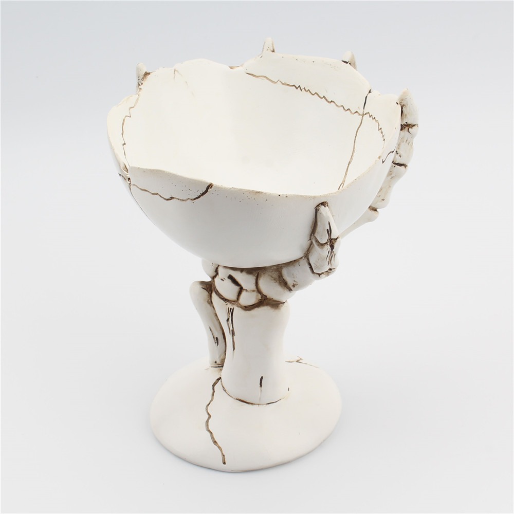 Top-down view into a cracked bone-white bowl with broken rim edges