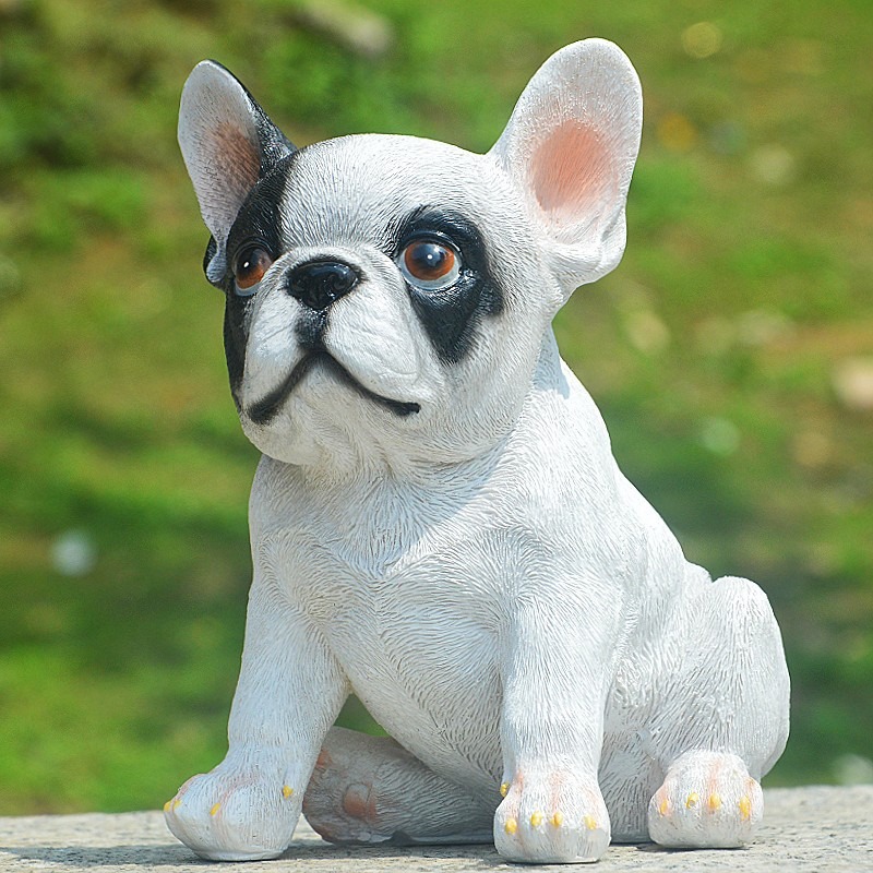 Sitting bulldog figurine showing painted face and yellow-tipped claws