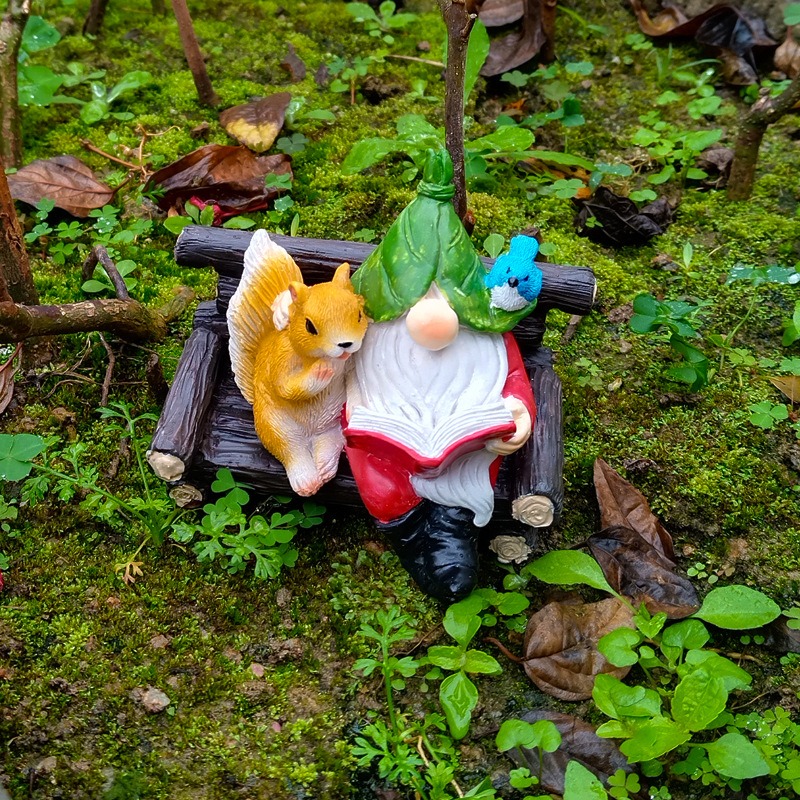 Gnome and squirrel bench set among moss and fallen leaves in a garden