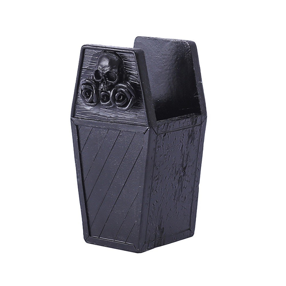 Matte black coffin organizer with carved skull and roses on the lid