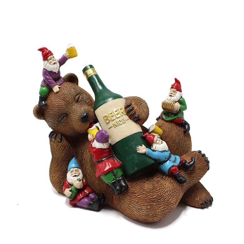 Side view of bear reclining with gnomes arranged around the bottle