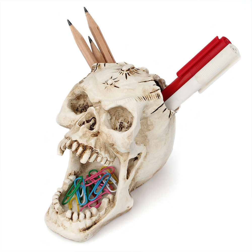 Skull organizer sitting on a desk with tidy pens and clips