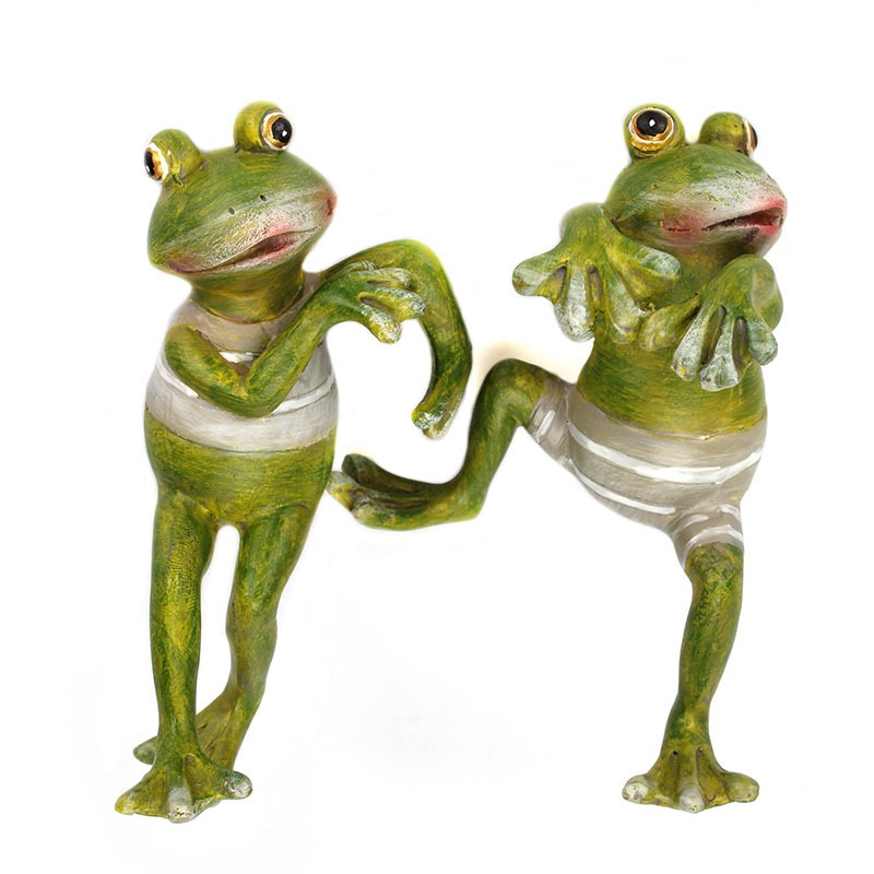 Two painted resin frogs standing together with striped bellies