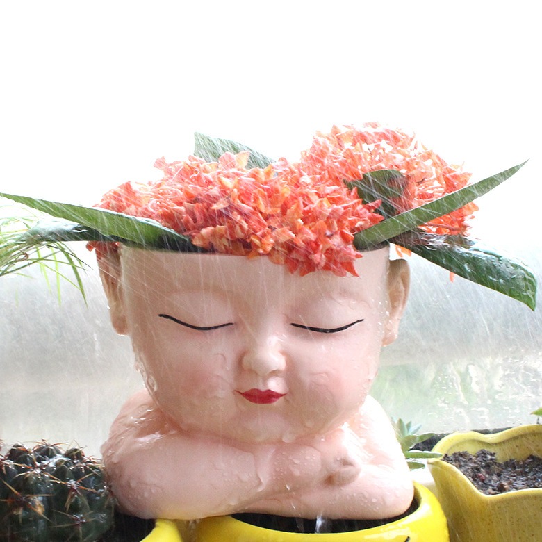 Boy face flower pot with brown hair and blue shirt, seated base